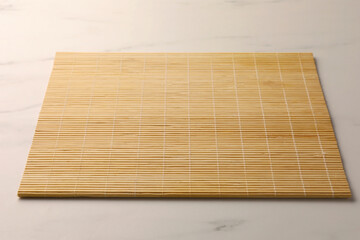 New bamboo mat on white marble table