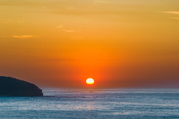 Soft hazy sunrise seascape and orange sky and full sun