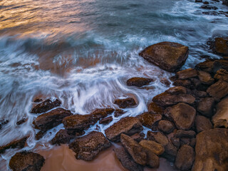 Sunrise views over the beach, sea and rocks