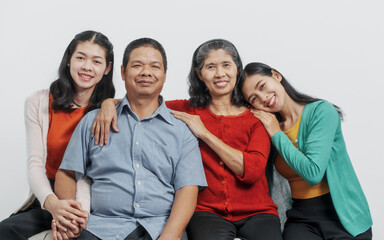 Looking camera, Happy anniversary day family of Elderly father and mother with old sister and young sister real people sitting together on sofa, Do activities together with love happily in the summer