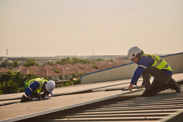 Two male engineer install solar panels.