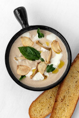 gourmet cream of mushroom soup in black ceramic bowl