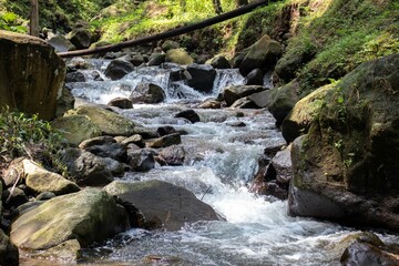 the beauty of the river flow in the mountains surrounded by tropical rainforest