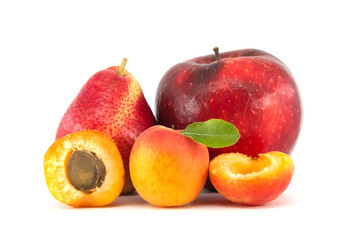 Whole and halved ripe apricot, pear and red apple