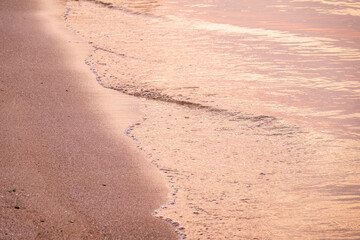 Soft wave of the sea on the sandy beach.