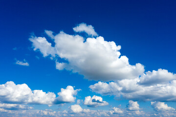 Naklejka na ściany i meble white fluffy clouds with rainbow in the blue sky