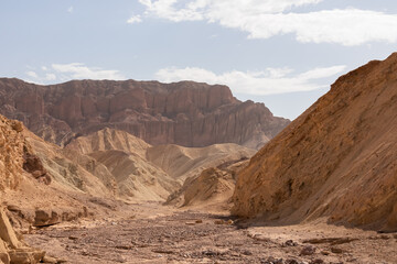 Golden Canyon trailhead with scenic view of colorful geology of multi hued Amargosa Chaos rock formations, Death Valley National Park, Furnace Creek, California, USA. Barren Artist Palette landscape