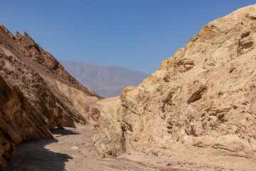 Golden Canyon trailhead with scenic view of colorful geology of multi hued Amargosa Chaos rock formations, Death Valley National Park, Furnace Creek, California, USA. Barren Artist Palette landscape