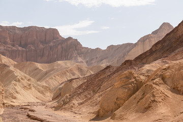 Golden Canyon trailhead with scenic view of colorful geology of multi hued Amargosa Chaos rock formations, Death Valley National Park, Furnace Creek, California, USA. Barren Artist Palette landscape