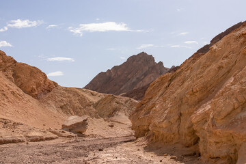 Golden Canyon trailhead with scenic view of colorful geology of multi hued Amargosa Chaos rock formations, Death Valley National Park, Furnace Creek, California, USA. Barren Artist Palette landscape