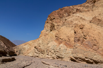 Golden Canyon trailhead with scenic view of colorful geology of multi hued Amargosa Chaos rock...