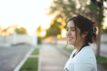 A latin teenager girl is smiling tot he camera before she stars her sports training