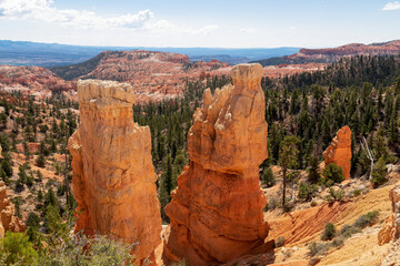 Scenic aerial view of Boat Mesa and massive hoodoo sandstone rock formation tower on Fairyland hiking trail in Bryce Canyon National Park, Utah, USA. Unique nature in barren landscape. Clouds emerging