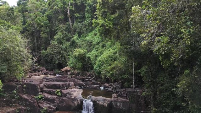 no people at dense rainforest jungle with lake waterfall. Marvelous aerial view flight 
thailand jungle Waterfall lake at koh kood Island 2022. ascending drone
4k uhd cinematic footage.