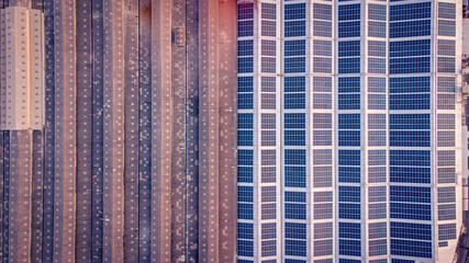 A large solar cell roof on an industrial building Generating electricity for the plant during daytime according to policies and measures to reduce global warming by taking high-angle shots from drones