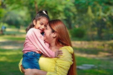 Indian woman with her little daughter at park