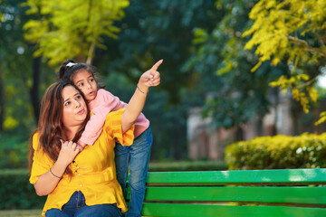 Indian woman with her little daughter at park