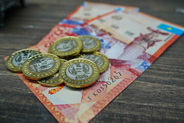Almaty, Kazakhstan - 04.05.2023 : A large handful of coins with a face value of 100 Kazakhstani...