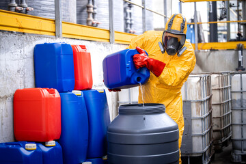 Professional chemicals industry worker in protective equipment making acids for zinc galvanizing.