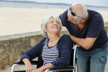 disabled older woman and husband enjoying summer vacation holidays