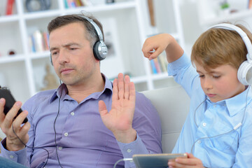 dad is asking his son to be quiet