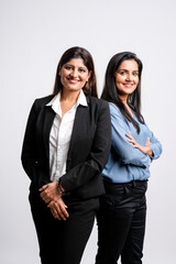 Young confident indian businesswoman standing on white background.