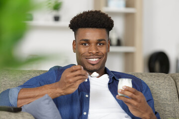 a young man eating yogurt