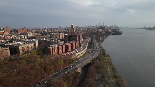 New York's West Side Highway and Hudson River. Evening traffic and city skyline. Harlem and Washington Heights, buildings and parks.