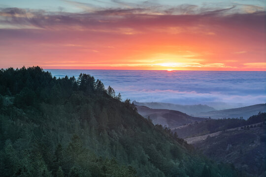 Dramatic Sunset over Santa Cruz Mountains and the Pacific Ocean via Purisima Creek Redwoods, San Mateo County, California, USA.