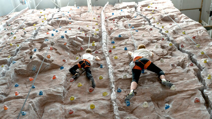 mom and son on the climbing wall. the concept of sports education