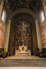 Fototapeta premium Monumental church building in Gothic in neo-romanesque arch style with large ceiling and altar murals and fresco, opulent detailed columns and marble structures