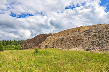 Big gravel heap on a meadow from a construction site