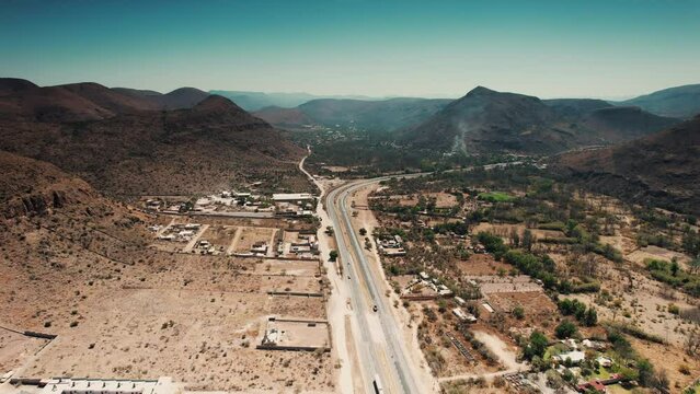 Aerial wide-angle drone shot of the highway and mountains near Queretaro, Mexico - Sandia Mountains Albuquerque New Mexico