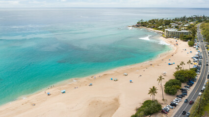 Green Mountains, ocean, and clouds on the west side of Oahu Hawaii at sunset time. Aerial top-down drone view.