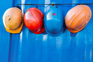 Multi-colored protective construction helmets. Coordinated work of the construction team. Safety in...