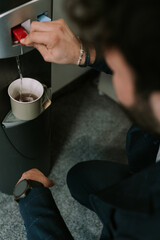 Above view, close up photo of young male person making himself a tea