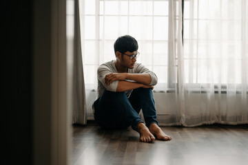 Man sit Depression Dark haired  pensive glance Standing by window