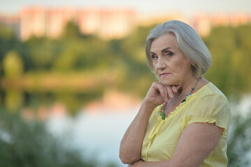 portrait of a beautiful sad old woman in summer