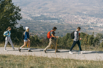 Four hikers walking in a row