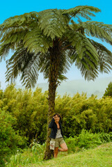 young woman under a palm tree, La Reunion, France