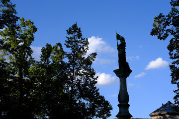 Silhouette of The Helmeted Statue of a Woman beside the Fountain at Lindenhof Hill Park.