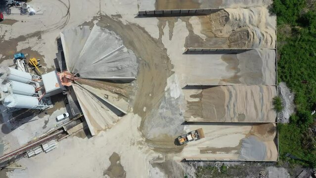 Aerial view of cement manufacturing plant. Working sand loading machines.