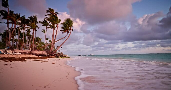 Beautiful ocean sunrise above the ripple water and beach shore, tropical morning on a island