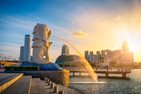 SINGAPORE-APRIL 30, 2018: Merlion statue fountain in Merlion Park and Singapore city skyline at sunrise sky morning. Merlion fountain is one of the most famous tourist attraction in Singapore.