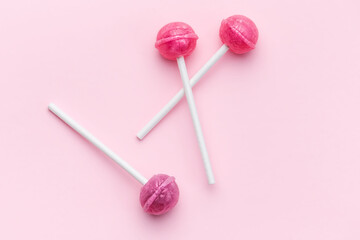 Sweet lollipops on pink background