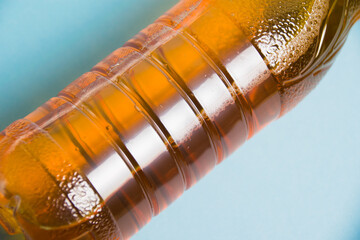 Apple juice in a plastic bottle on a blue background. Concept of earth day, zero waste and plastic...
