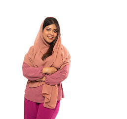 portrait of Asian girl in hijab standing with crossed hands on an isolated background