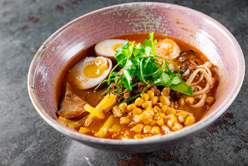 Asian noodle soup, ramen with chicken, tofu, vegetables and egg in bowl
