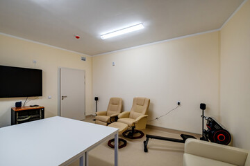 relaxation room with chairs and exercise equipment in office for rest and relax of staff
