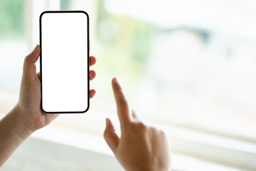 Hand holding empty white screen smart phone on white background.